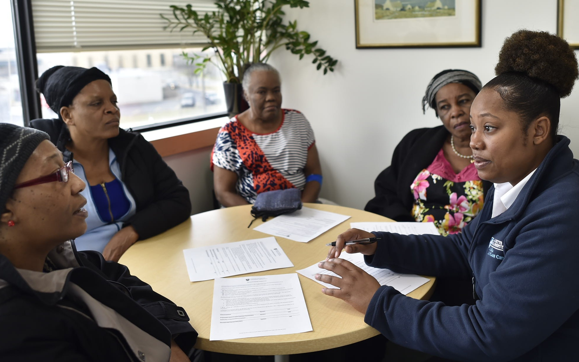 Community health workers meet around a table